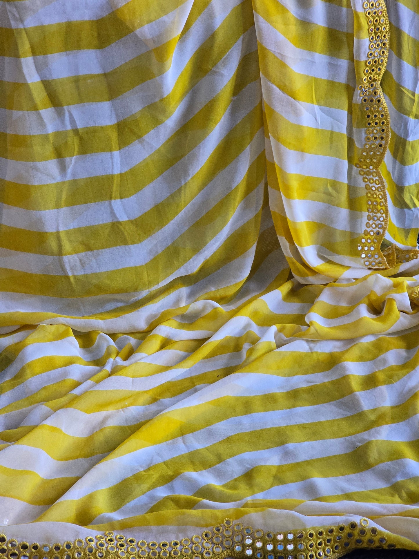 Yellow/white chiffon saree with border mirror work- stitched sleeveless blouse