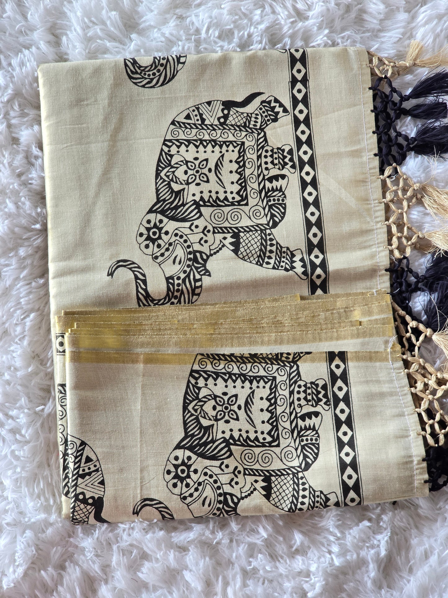 Tissue set saree with black elephant print on border and pallu