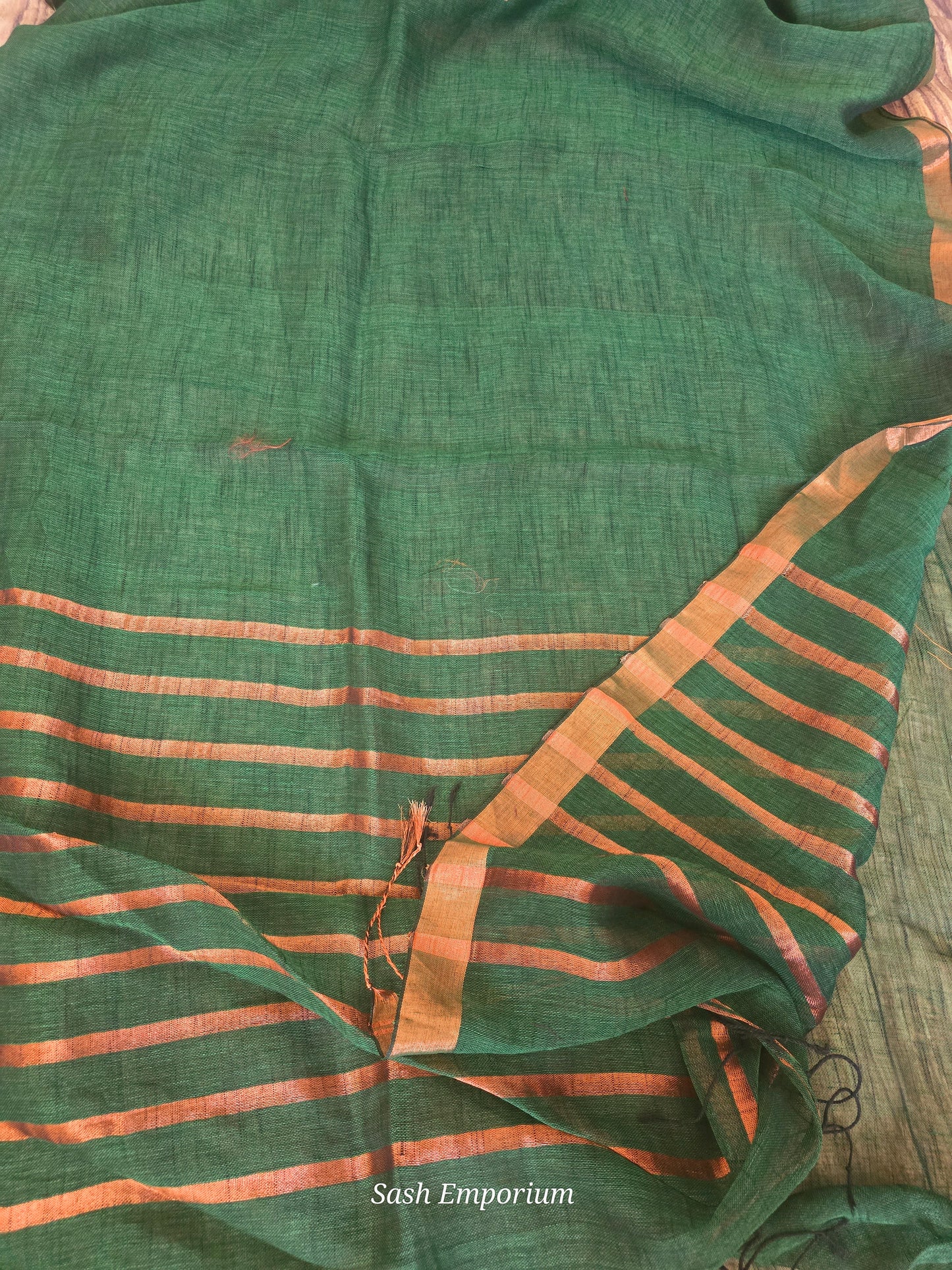 Bottle green/copper linen saree with stitched blouse