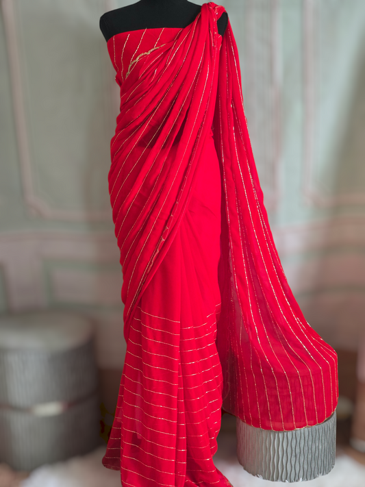 Bright red designer Georgette Saree with stitched sleeveless blouse